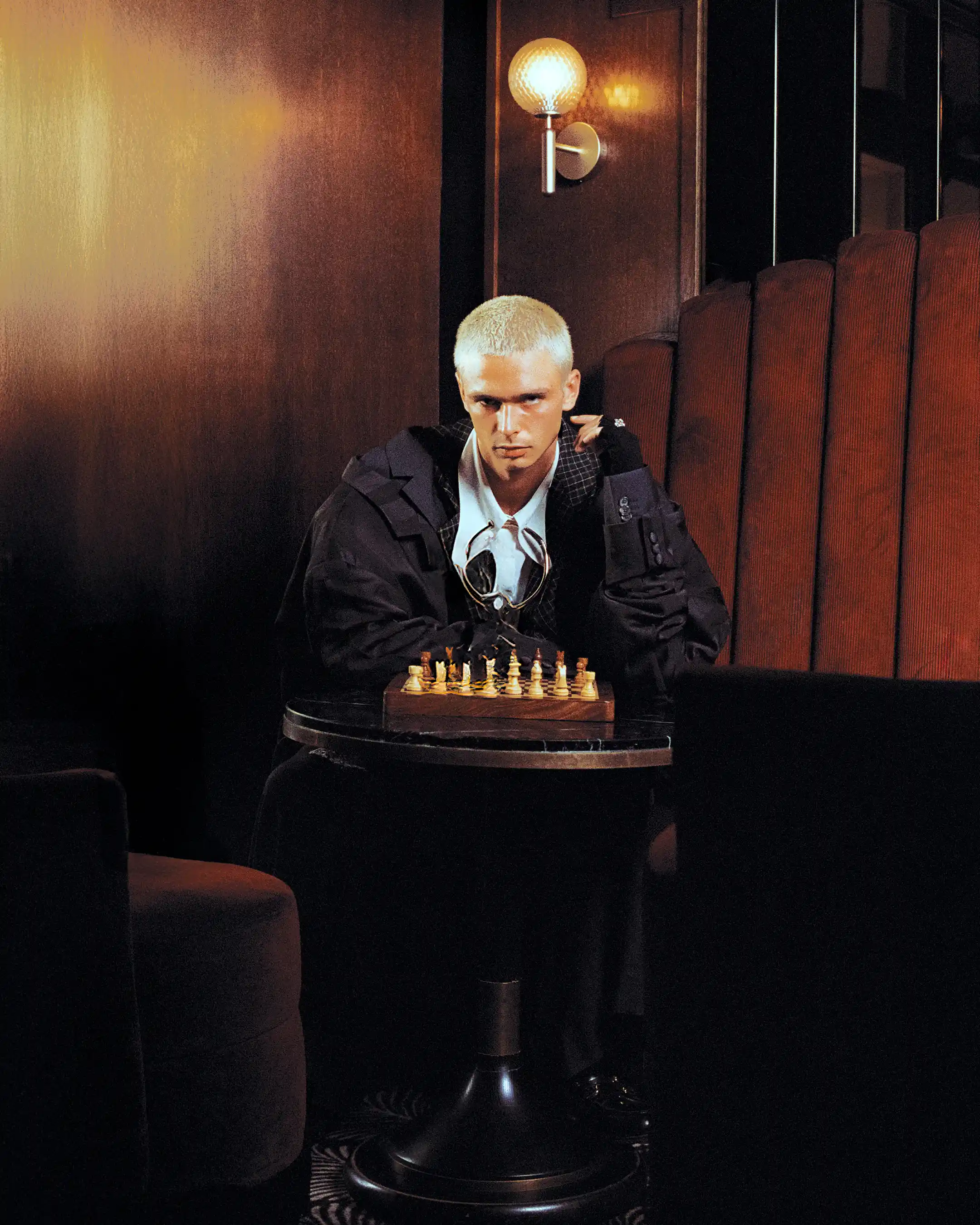 Matheo working the board like a puppeteer, white strings running from his fingers down to the chess pieces