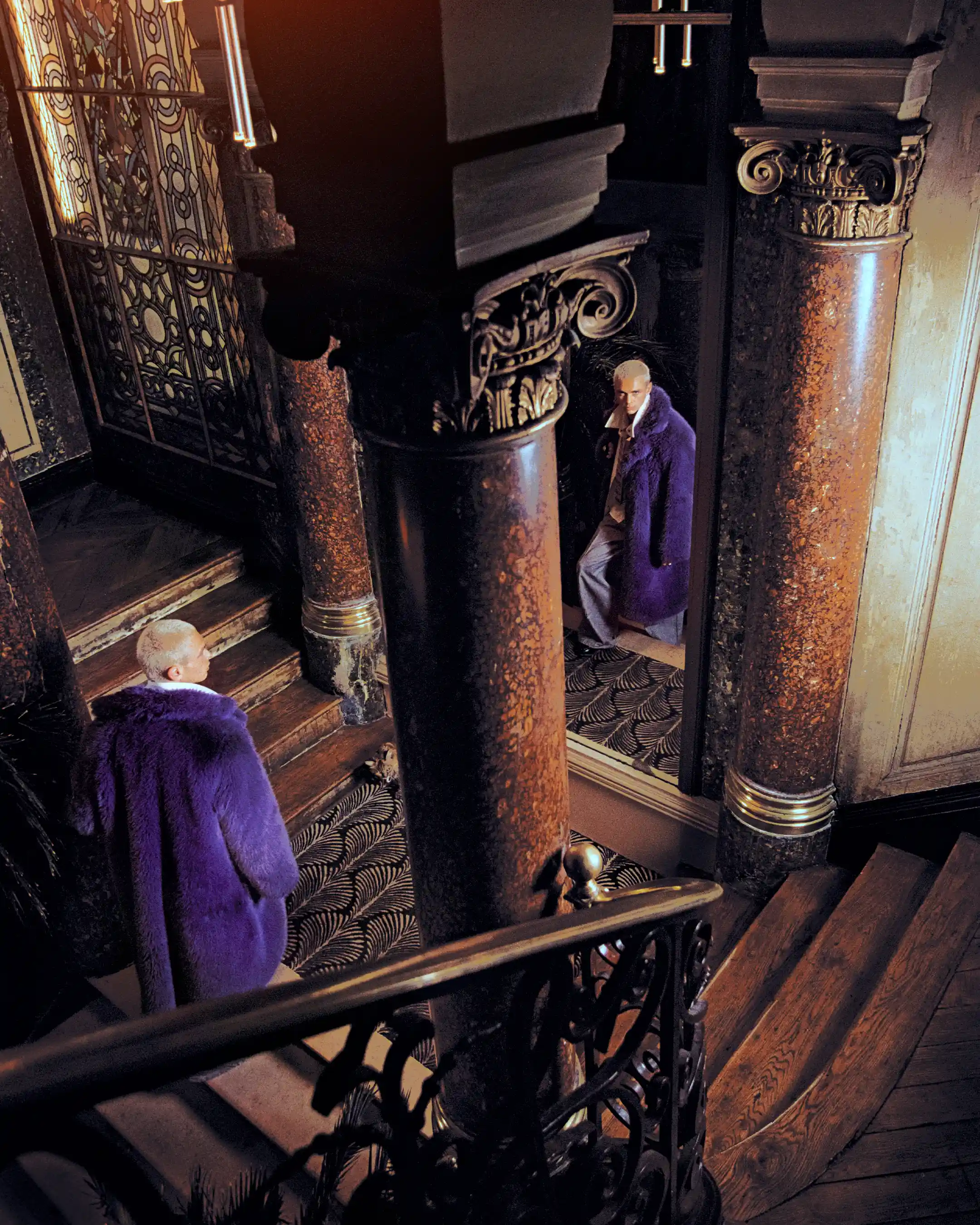 Wide staircase frame between marble columns, Matheo doubled in a purple fur coat on two levels