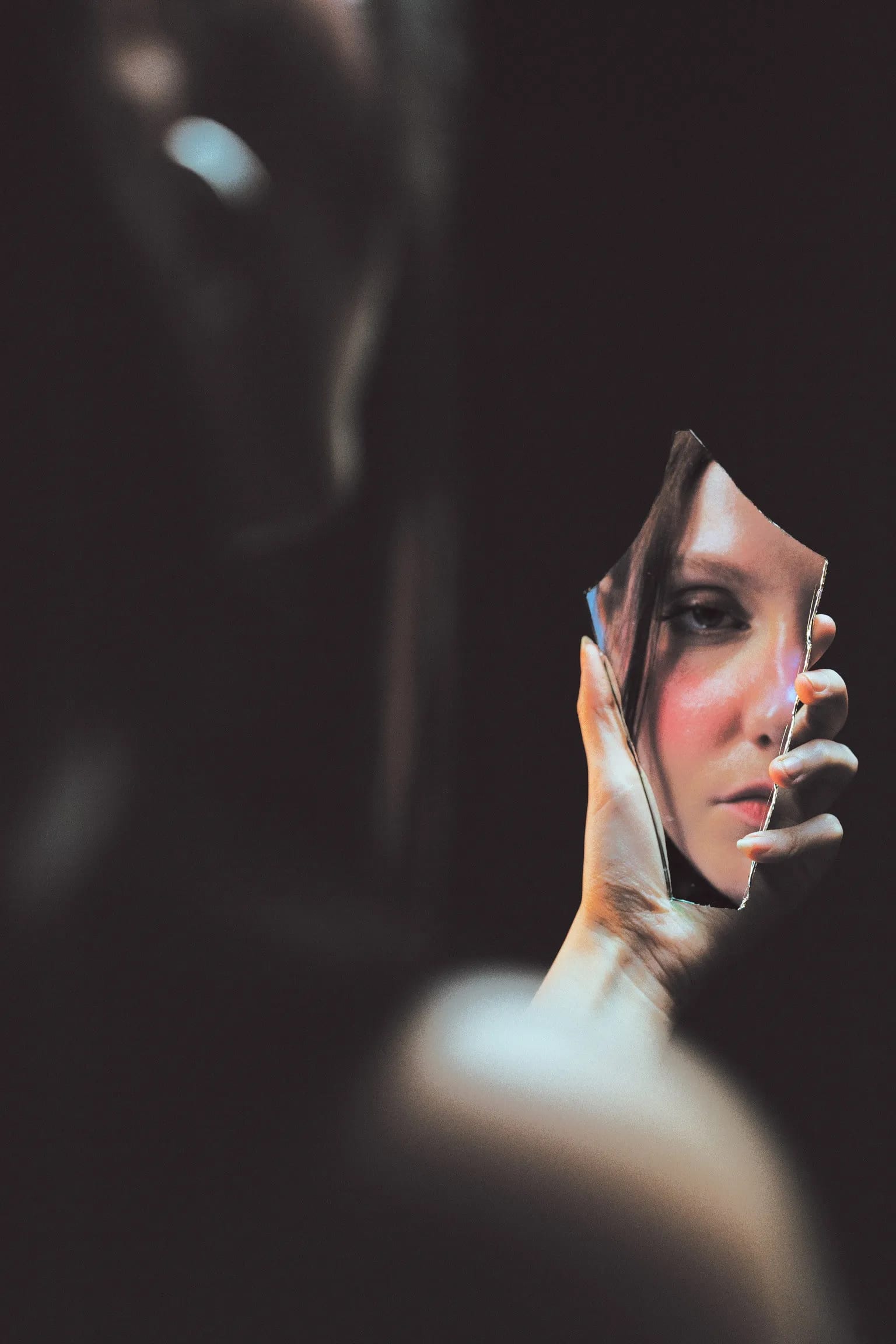 Close portrait of Marie L. doubled by a reflective surface