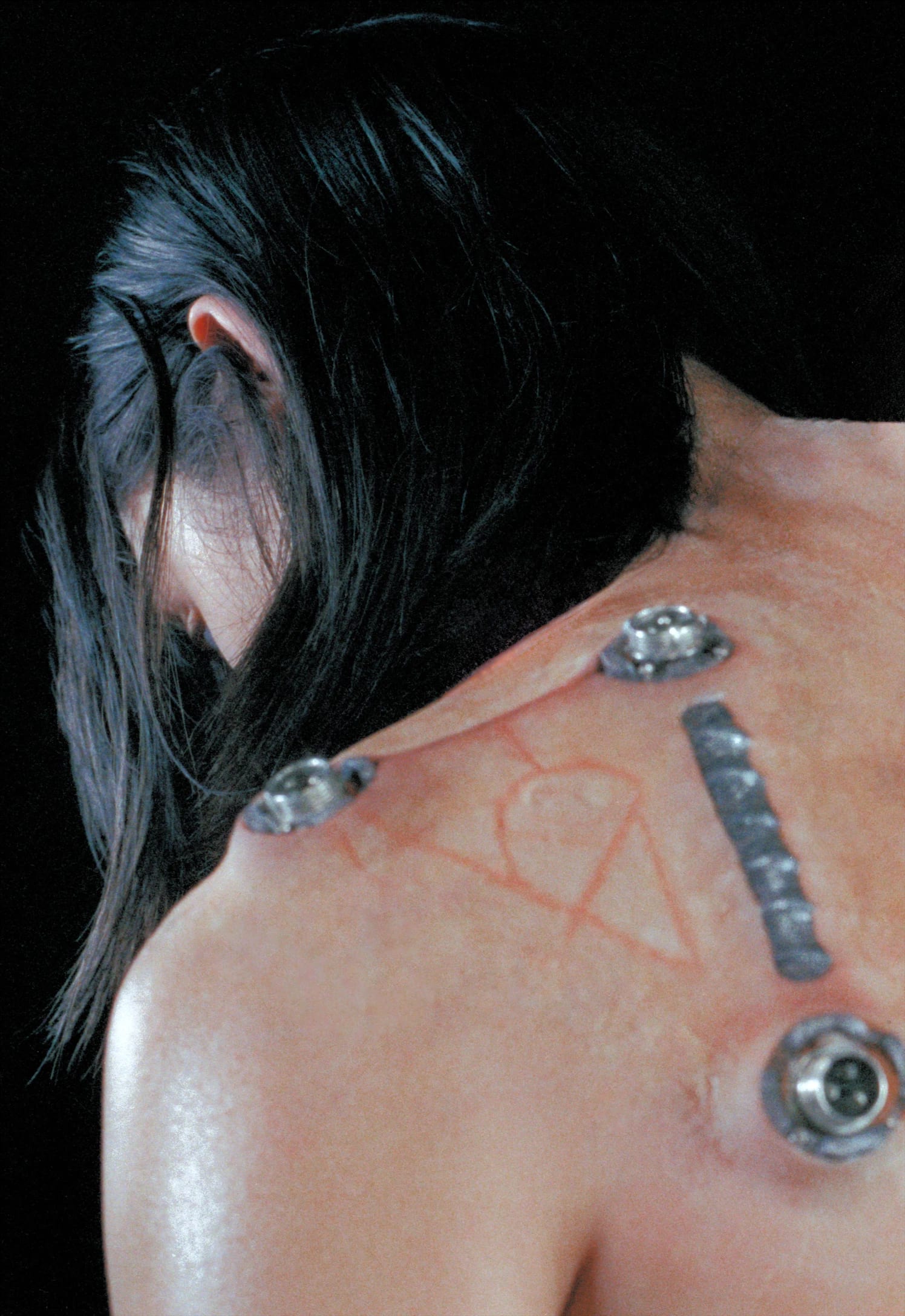 Portrait frame of a cast member in SFX makeup and cables